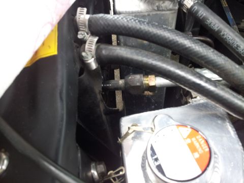1976 Ford Ranchero - Close-up view of hoses and a radiator cap in an engine bay, with visible text on the cap.