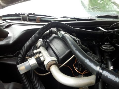 1976 Ford Ranchero - Engine bay view showing air conditioning lines and hoses, with some text visible on a black hose.