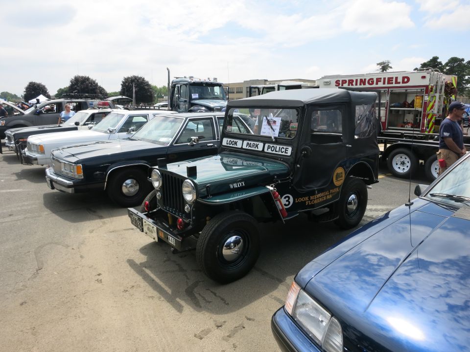 Green Jeep marked Look Park Police beside fire truck and sedans