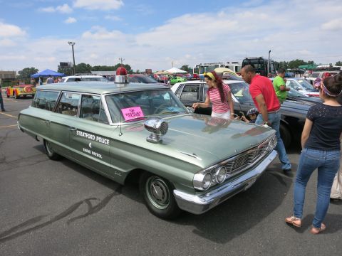 1991 Ford LTD Crown Victoria - green vintage Ford station wagon lettered Stratford Police Radio Patrol with a roof light draws onlookers at an outdoor show.