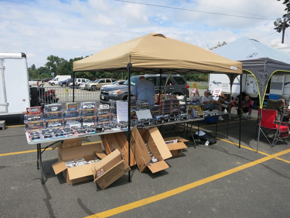 Vendor tent selling boxed diecast model cars at outdoor show