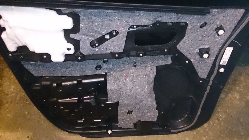 car door panel with insulation and speaker housing removed