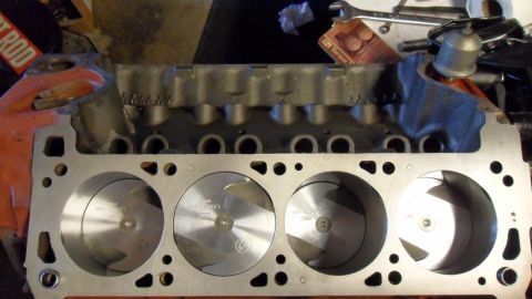 1972 Ford Ranchero - Close-up view of an engine block's cylinders and pistons, with some workshop tools in the background.