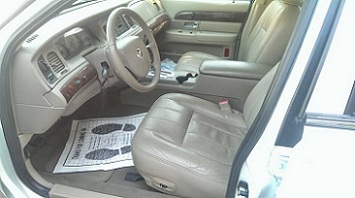 2000 Mercury Grand Marquis - The interior of a 2000 Mercury Grand Marquis shows tan leather seats, dashboard, and door panels.