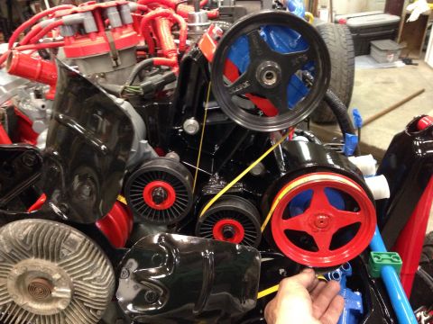 1993 Ford Bronco - Close-up view of engine components including pulleys, belts, and a distributor cap.