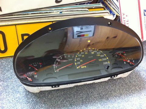 1999 Ford Fairlane - A dashboard gauge cluster is shown, a speedometer, tachometer, and fuel and temperature gauges.