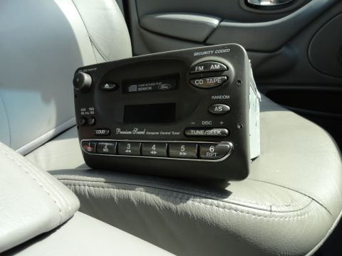 1999 Ford Fairlane - This Ford car stereo unit features a CD player, tape deck, and radio controls.