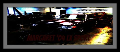 2004 Ford Crown Victoria - A dark 2004 Ford Crown Victoria LX Sport sedan is visible in a garage, with text overlaying the image.