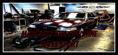 2004 Ford Crown Victoria - A 2004 Ford Crown Victoria is positioned on a dynamometer in a workshop setting.