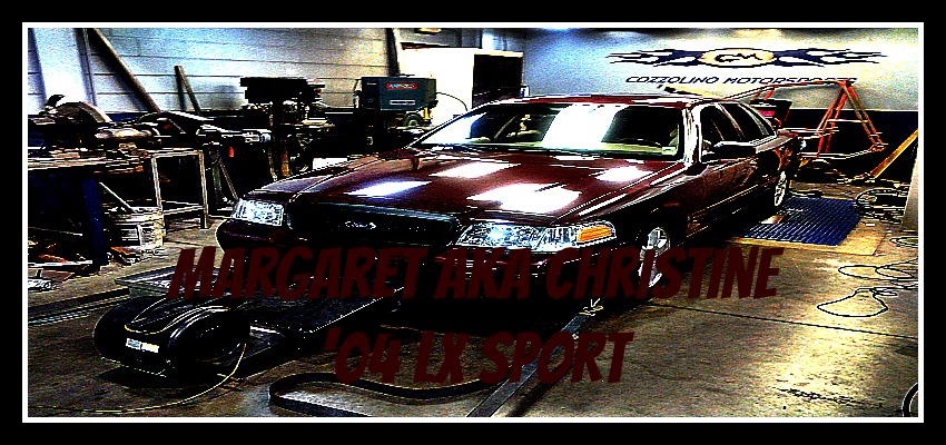 2004 Ford Crown Victoria on a dynamometer in a garage with "MARGARET AND CHRISTINE 2004 LX SPORT" text overlay
