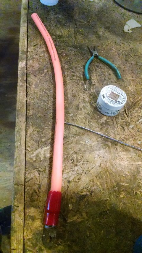 1995 Ford Bronco - Tools and a flexible hose are laid out on a workbench, suggesting a repair or DIY project.