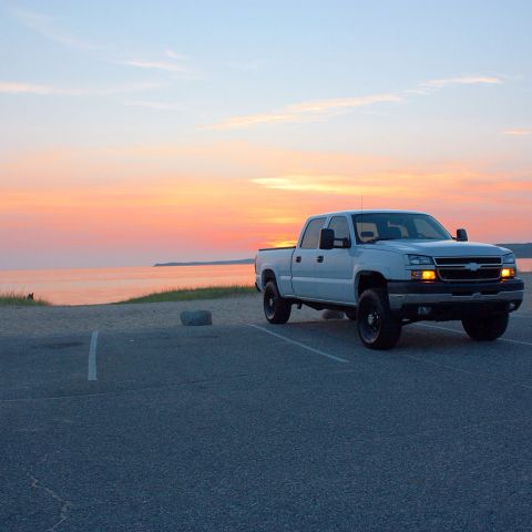2006 Chevrolet Silverado 2500 - White 2006 Chevrolet Silverado 2500 parked by the water during a sunset.