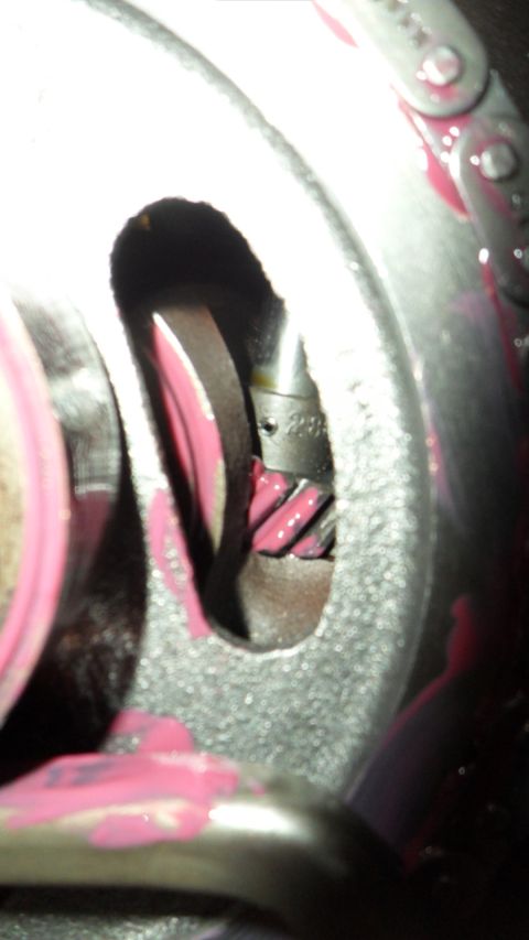 1972 Ford Ranchero - A close-up view of engine timing components, including a chain and gears, coated in pink lubricant.
