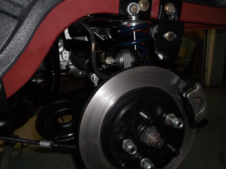 close-up of a car's rear suspension and disc brake assembly