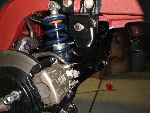 1967 Ford Mustang - Close-up view of a vehicle's rear suspension and brake system components.