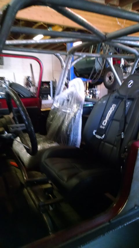 1985 Jeep CJ7 - Modified Jeep interior features racing seats with "Crower" harnesses and a prominent roll cage structure.