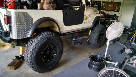 1985 Jeep CJ7 - This 1985 Jeep CJ7 features large off-road tires and diamond plate accents on the rear quarter panel.