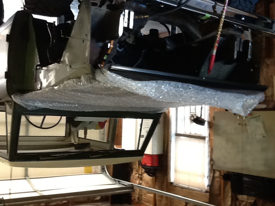 Car interior with bubble wrap on the dashboard, undergoing work