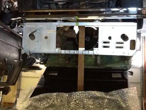 1988 Suzuki Samurai - Close-up view of vehicle chassis and body panels, possibly during restoration or assembly.