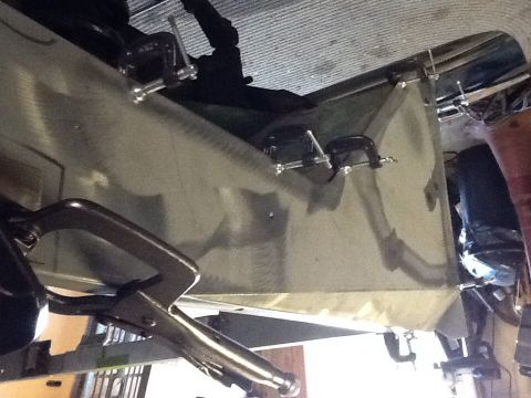 1988 Suzuki Samurai - A metal panel is held in place with various clamps and pliers, suggesting a repair or modification process.
