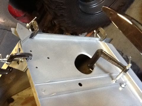 1988 Suzuki Samurai - A metal panel is being worked on, held in place by clamps, with a circular opening visible.