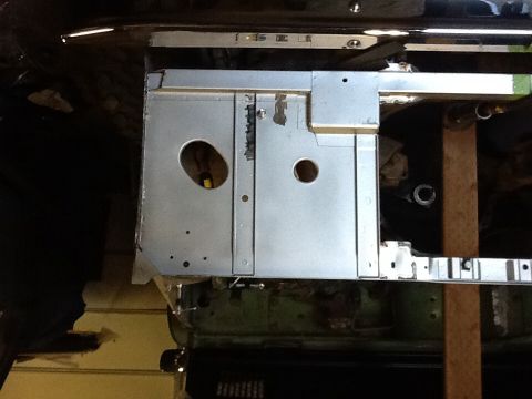 1988 Suzuki Samurai - Close-up view of unpainted metal chassis components, showing various holes and structural elements.