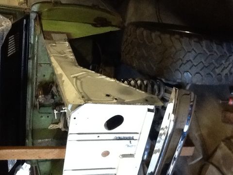 1988 Suzuki Samurai - The chassis and spare tire of a 1988 Suzuki Samurai are visible in this photo, suggesting it is undergoing maintenance or restoration.