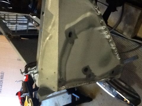 1988 Suzuki Samurai - A section of a vehicle's body is shown, with visible rivets and signs of repair work.