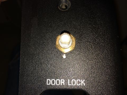 1997 Ford F-350 - Detail of a door lock switch on a black textured panel, with SuperMotors.net logo visible.