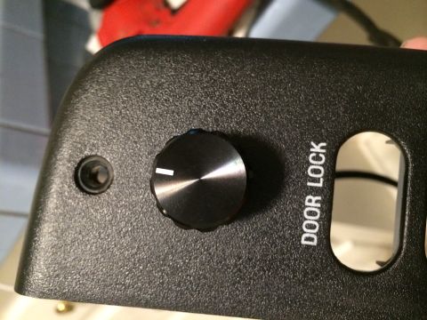 1997 Ford F-350 - A close-up view of a vehicle's interior door panel, showing a control knob and the 'DOOR LOCK' indicator.