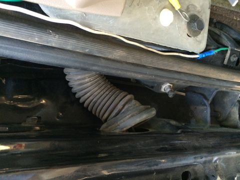 1997 Ford F-350 - Close-up view of wiring and a protective loom under the interior trim of a vehicle.