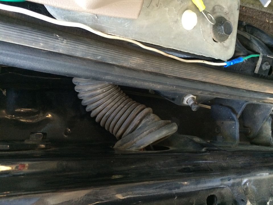 Corrugated wire loom and wiring under a vehicle's interior trim panel
