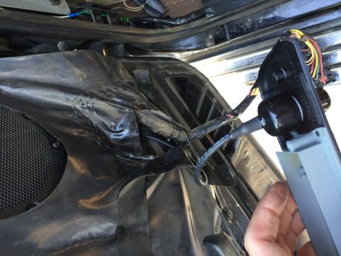 1997 Ford F-350 - Close-up of wiring and a connector being worked on inside a vehicle's door panel.