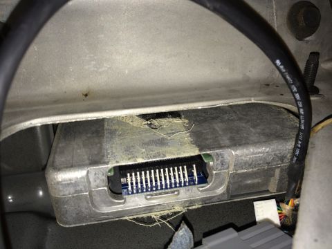 1997 Ford F-350 - An electronic control module with a visible connector and wiring harness is shown in this close-up view.