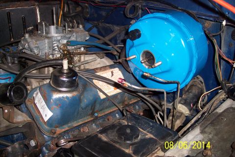 1978 Ford Bronco - Close-up view of the engine bay in a 1978 Ford Bronco, showing the brake booster and carburetor.