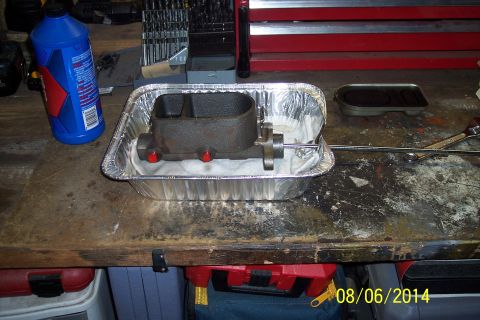 1978 Ford Bronco - Brake master cylinder in a foil pan with brake fluid and tools on a workbench.