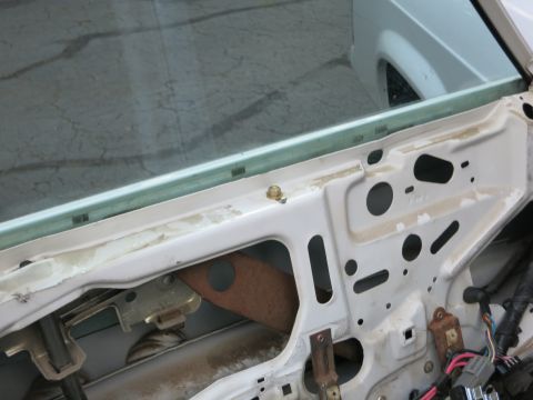 1991 Ford LTD Crown Victoria - Interior view of a car door, revealing the window regulator and electrical components.