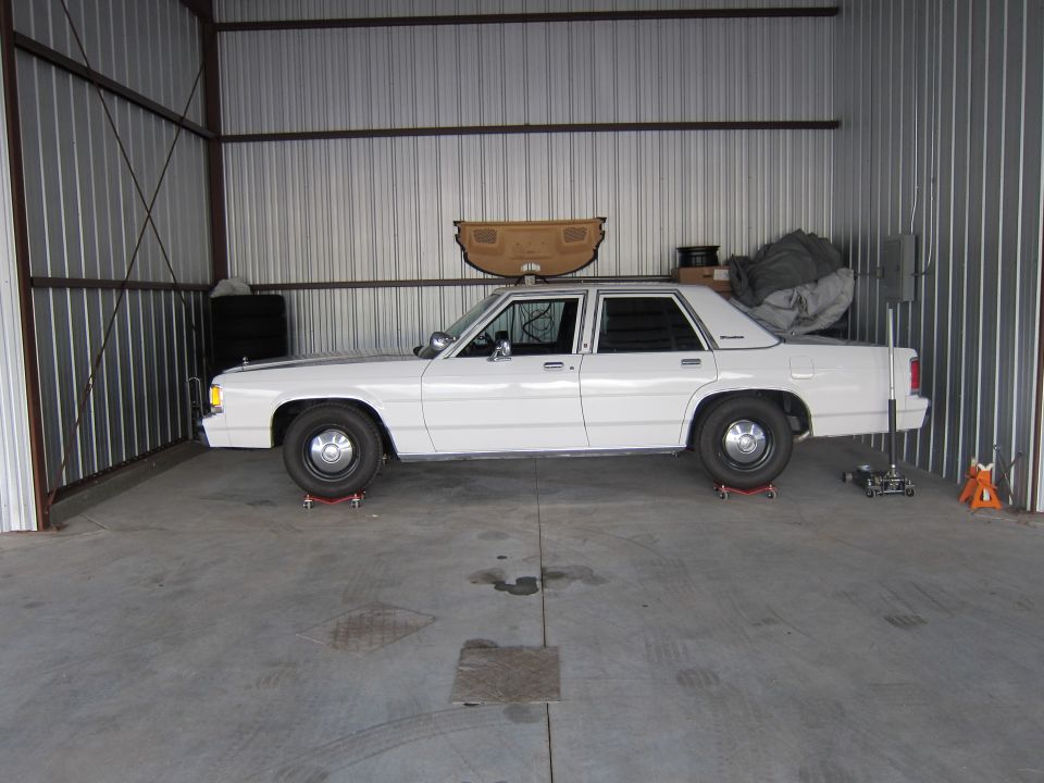 White 1991 Ford Crown Victoria LTD sedan parked inside a metal building