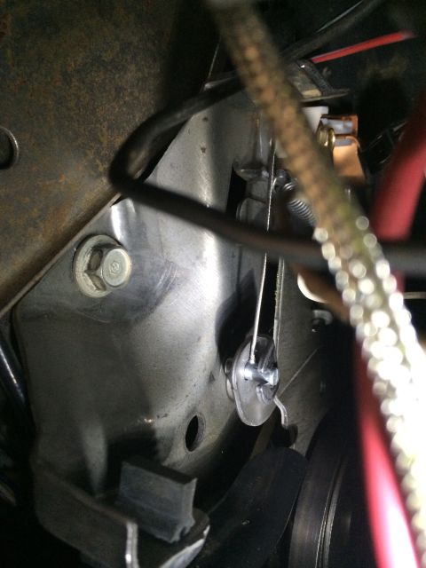 1997 Dodge 3500 - Detail of the parking brake cable mechanism, including a spring and linkage, mounted to a metal bracket.