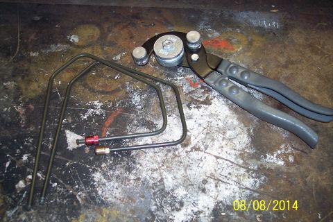 1978 Ford Bronco - A tube bender and pre-bent brake lines are laid out on a work surface.