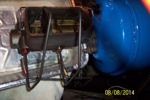1978 Ford Bronco - This photo shows a vehicle's master cylinder and brake booster assembly, with brake lines attached.