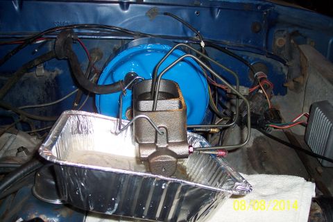 1978 Ford Bronco - Close-up of a master cylinder and brake booster assembly, likely during maintenance.