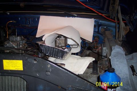 1978 Ford Bronco - The engine bay shows a carburetor and brake master cylinder, with a blue fluid bottle nearby.