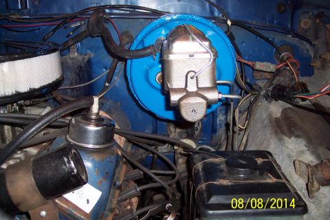 1978 Ford Bronco - Close-up view of engine bay components, including the brake booster and master cylinder, with visible wiring and hoses.
