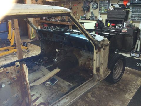 1964 Ford Fairlane - The interior of a 1964 Ford Fairlane shows significant rust and disrepair, with tools scattered on the floor.