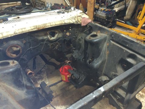 1964 Ford Fairlane - The engine bay of a car is shown with the engine removed, revealing the internal structure and firewall.