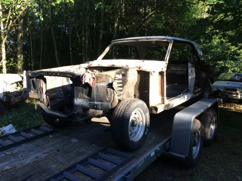 1964 Ford Fairlane - A deconstructed 1964 Ford Fairlane sits on a trailer, awaiting restoration.