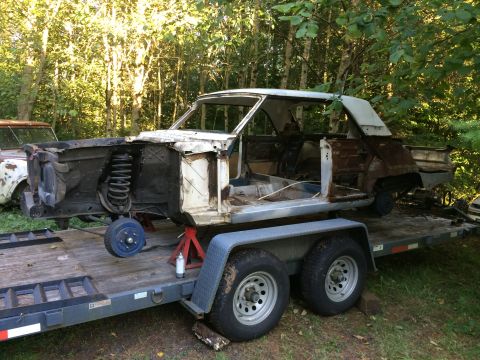1964 Ford Fairlane - A disassembled 1964 Ford Fairlane body sits on a trailer, awaiting restoration.