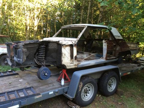1964 Ford Fairlane - A 1964 Ford Fairlane body sits on a trailer, stripped down and awaiting restoration.