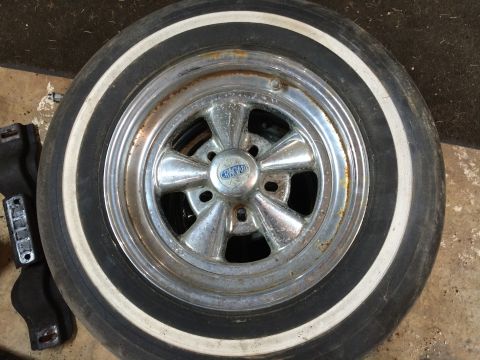 1964 Ford Fairlane - A close-up view of a Cragar wheel with a whitewall tire, showing signs of wear and rust.